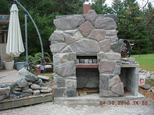 outdoor granite fireplace under construction
